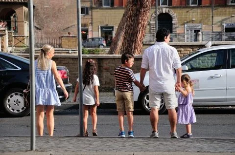 Mother, father and their three children crossing a street in the center of Rome Stock Photos