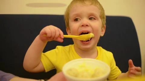 Mother feeding her son at the table Stock Footage 58482181
