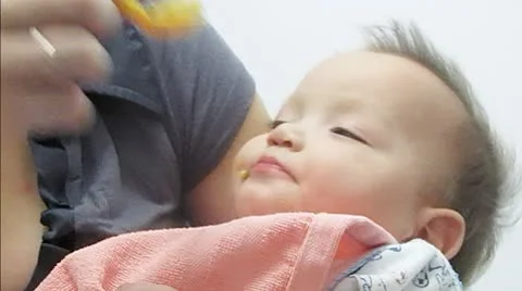 Mother feeds babby Stock Footage 10597975