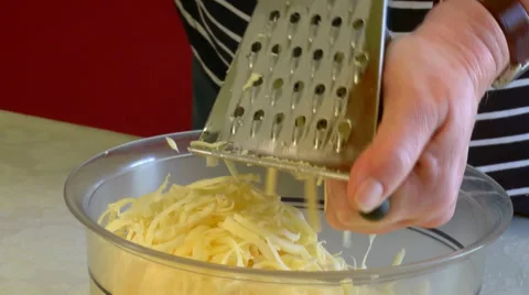 Mother grating cheese for pizza Stock Footage 55875343