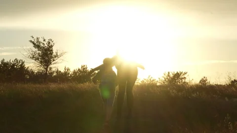 Mother greeting son with backpack at sunset Stock Footage 317335527