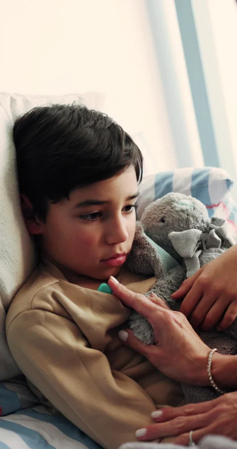 Mother, help and sick child in bed with comfort, thermometer and monitor Stock Footage 339133110