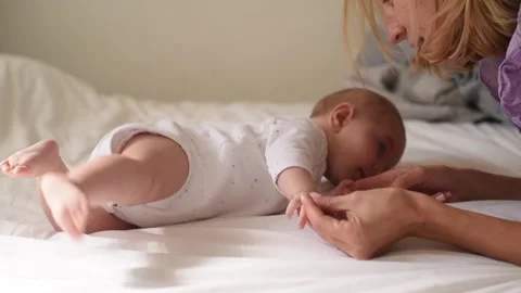 Mother help to do exercise and gymnastic for child. Stock Footage 230903072