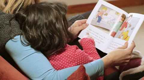 Mother helping child to read Stock Footage 961104