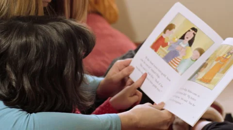 Mother helping child to read Stock Footage 975672