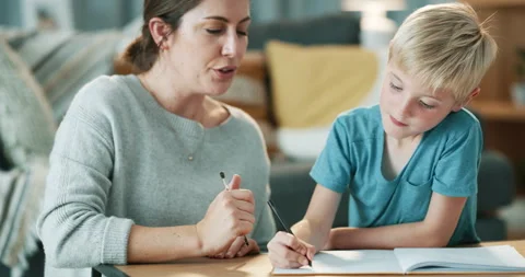 Mother helping, child thinking and writing for education, learning and support Stock Footage 257933255