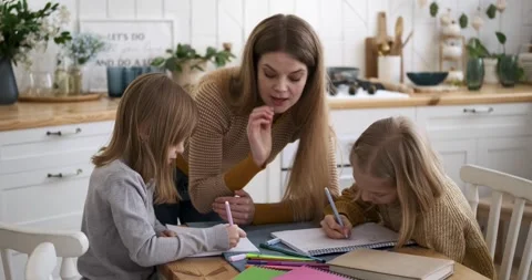 Mother helping children in solving mathematics problems Stock Footage 238997438