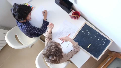 Mother helping her son do homework back to schoo Vídeos de archivo 270483884