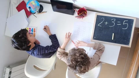 Mother helping her son do homework back to schoo Vídeos de archivo 270483899