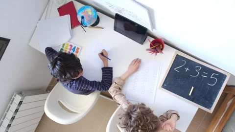 Mother helping her son do homework back to schoo Vídeos de archivo 270483901