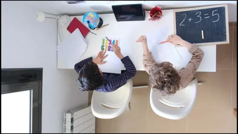 Mother helping her son do homework back to schoo Video stock 270483928