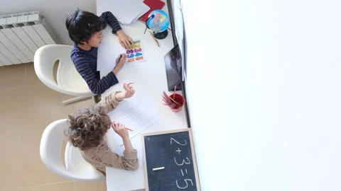 Mother helping her son do homework back to schoo Video stock 270483937