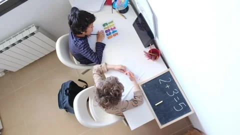 Mother helping her son do homework back to schoo Video stock 270483951