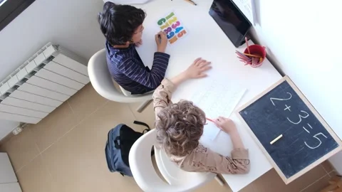 Mother helping her son do homework back to schoo Video stock 270483958