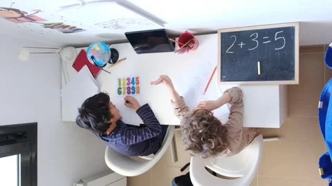 Mother helping her son do homework back to schoo Video stock 270483969