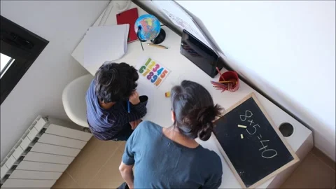 Mother helping her son do homework back to schoo Video stock 270483984