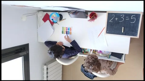 Mother helping her son do homework back to schoo Video stock 270483987