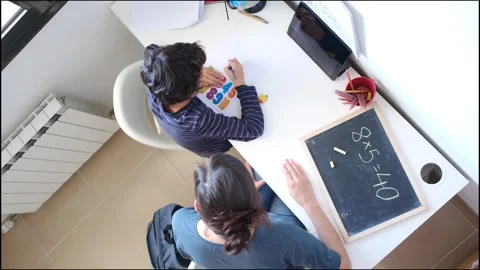 Mother helping her son do homework back to school. Video stock 270483993