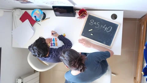 Mother helping her son do homework back to school. Video stock 270484006
