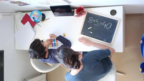 Mother helping her son do homework back to school. Video stock 270484008
