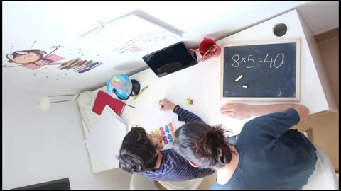 Mother helping her son do homework back to school. Video stock 270484017