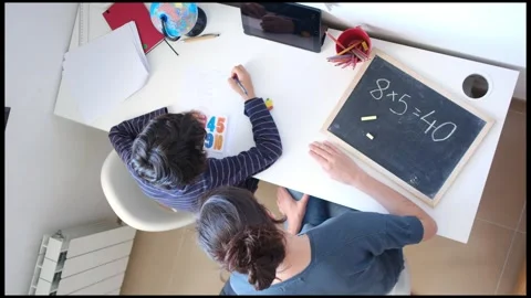 Mother helping her son do homework back to school. Video stock 270484018