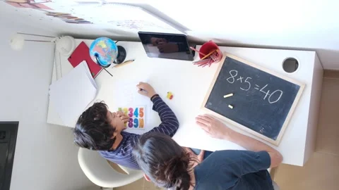 Mother helping her son do homework back to school. Video stock 270484024