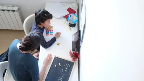 Mother helping her son do homework back to school. Video stock 270484040