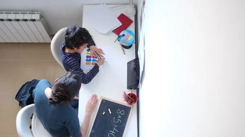Mother helping her son do homework back to school. Video stock 270484051