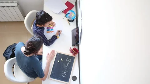 Mother helping her son do homework back to school. Video stock 270484063