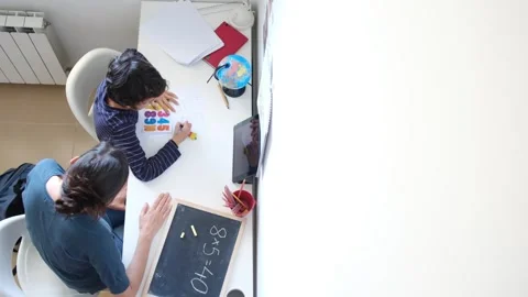 Mother helping her son do homework back to school. Video stock 270484064
