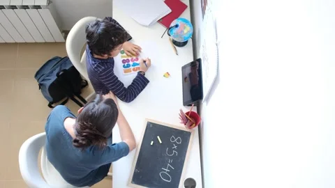 Mother helping her son do homework back to school. Video stock 270484073