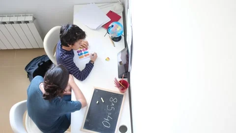 Mother helping her son do homework back to school. Video stock 270484087