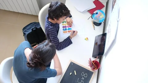 Mother helping her son do homework back to school. Video stock 270484093