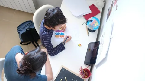 Mother helping her son do homework back to school. Video stock 270484100