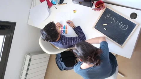 Mother helping her son do homework back to school. Video stock 270484105