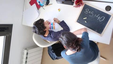 Mother helping her son do homework back to school. Vidéo 270484110