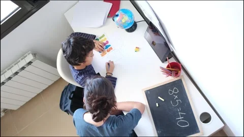 Mother helping her son do homework back to school. Video stock 270484115