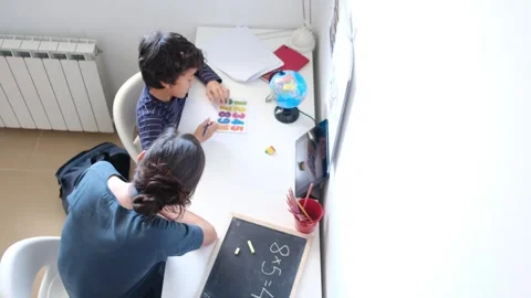 Mother helping her son do homework back to school. Video stock 270484135