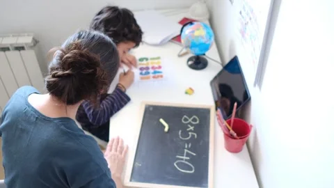 Mother helping her son do homework back to school. Video stock 270484142