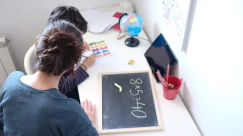 Mother helping her son do homework back to school. Video stock 270484146