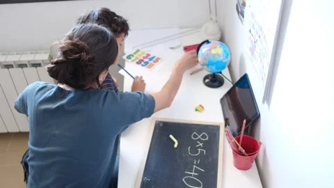 Mother helping her son do homework back to school. Video stock 270484157