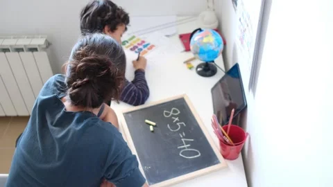 Mother helping her son do homework back to school. Video stock 270484160
