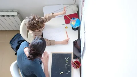 Mother helping her son do homework back to school. Video stock 270484168