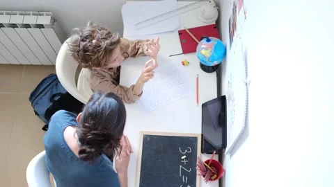 Mother helping her son do homework back to school. Video stock 270484171