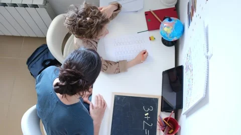 Mother helping her son do homework back to school. Video stock 270484179