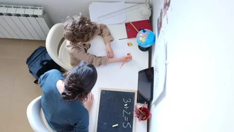 Mother helping her son do homework back to school. Video stock 270484188