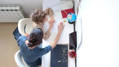 Mother helping her son do homework back to school. Video stock 270484201