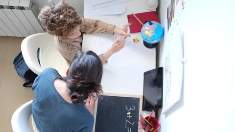 Mother helping her son do homework back to school. Video stock 270484205