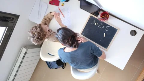 Mother helping her son do homework back to school. Video stock 270484209